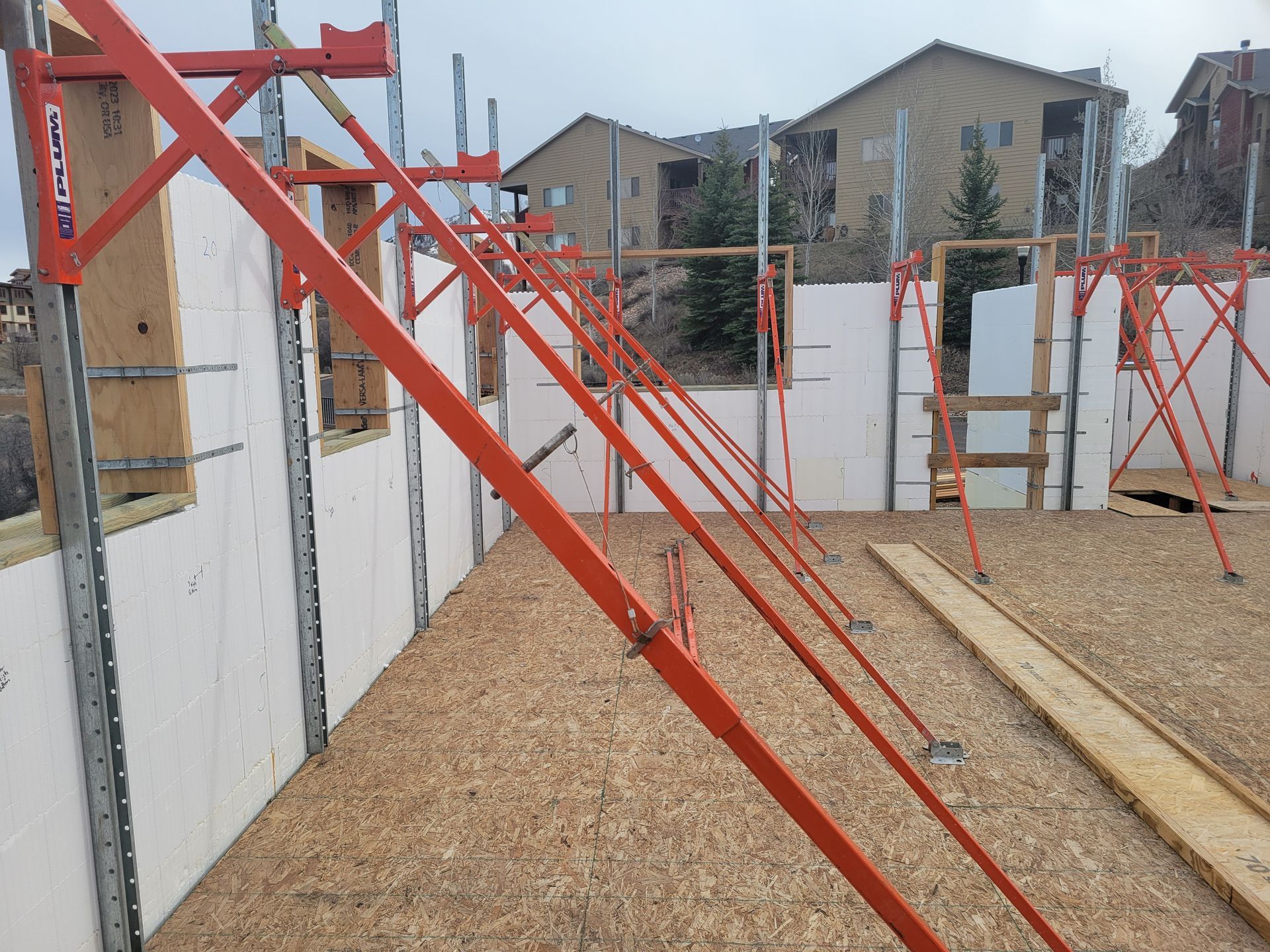 A construction site with a lot of scaffolding and a building in the background