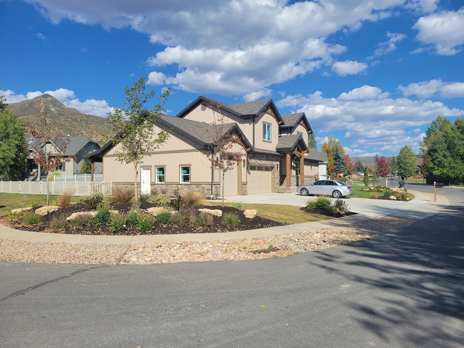 A large house with a car parked in front of it.