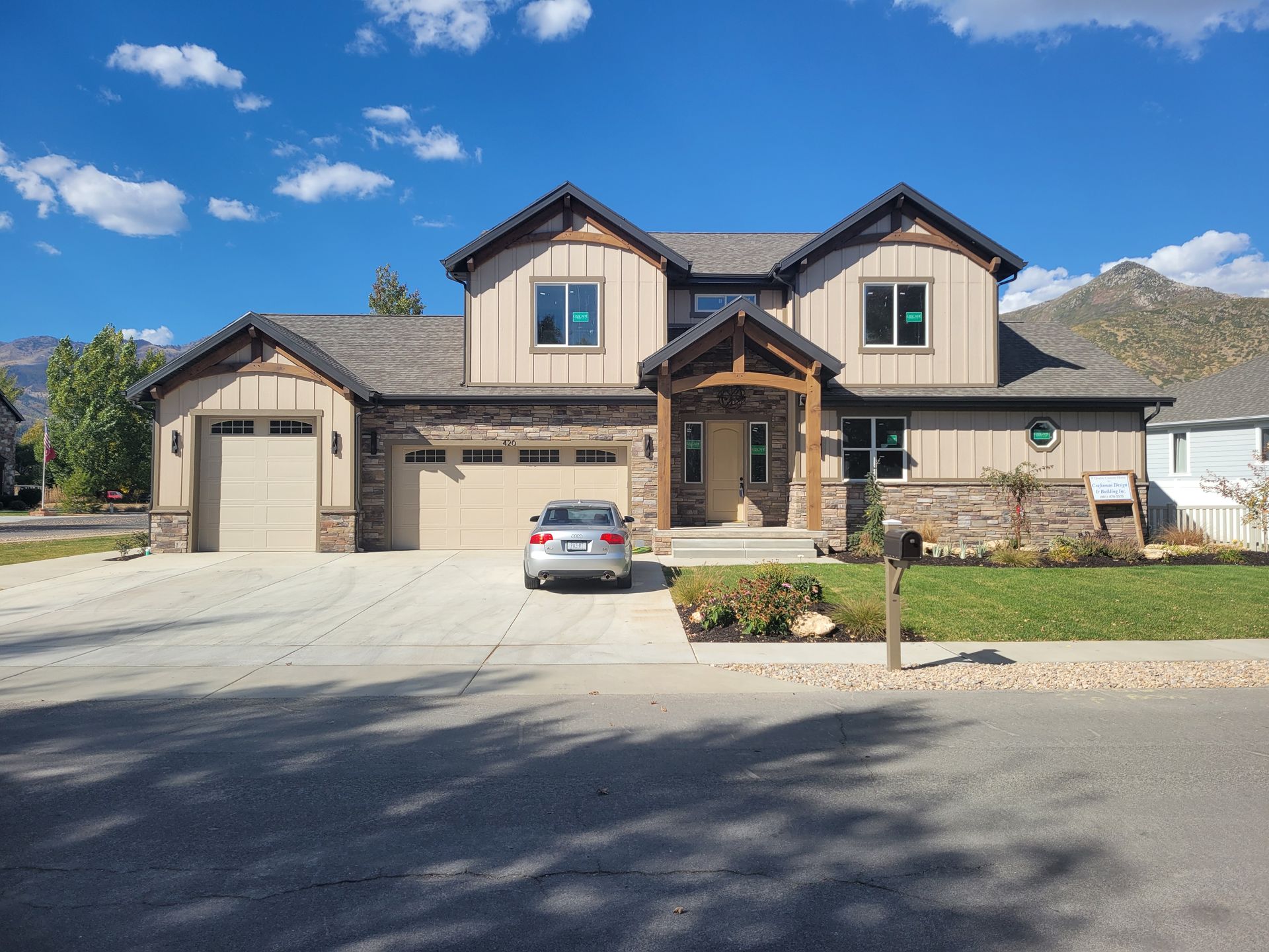 A large house with a car parked in front of it