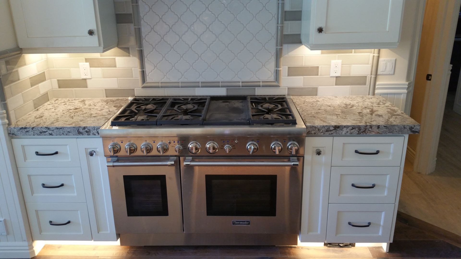A kitchen with stainless steel appliances and granite counter tops.