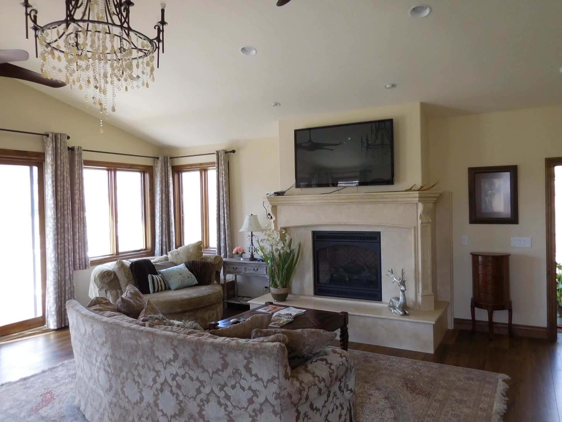 A living room with a fireplace and a flat screen tv