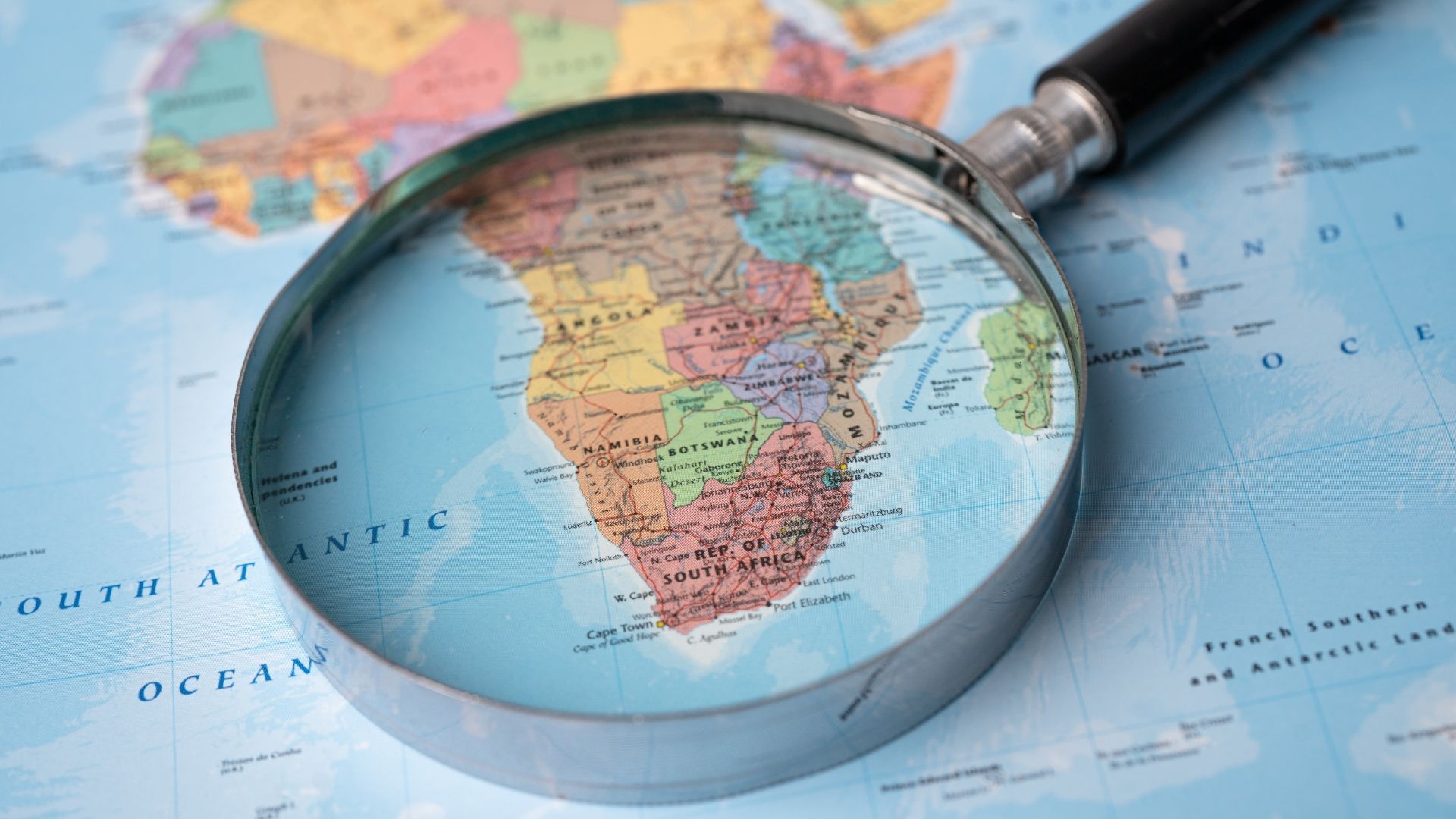 A magnifying glass is sitting on top of a map of africa.