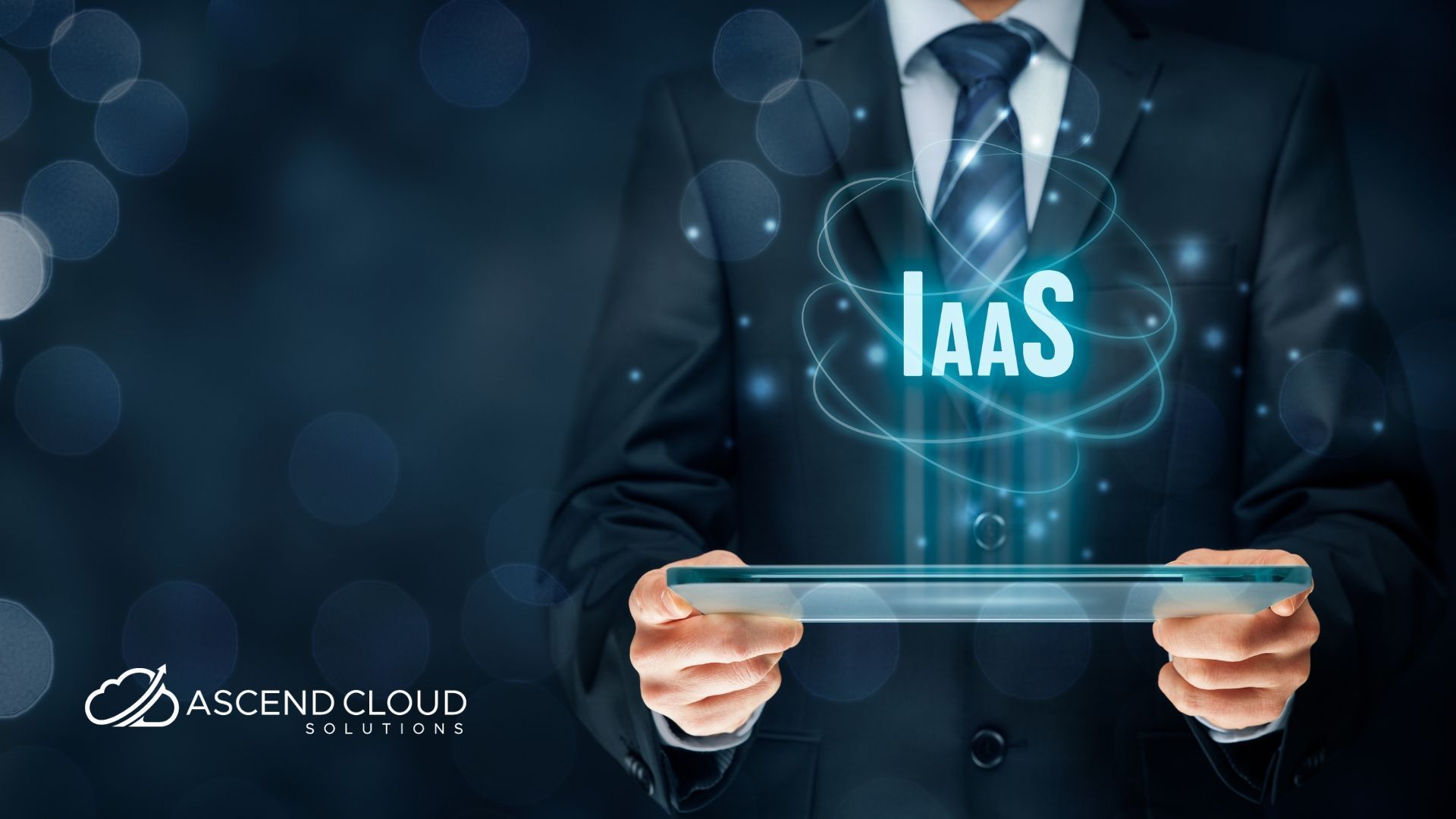 A man in a suit and tie is holding a tablet with the word iaas coming out of it.