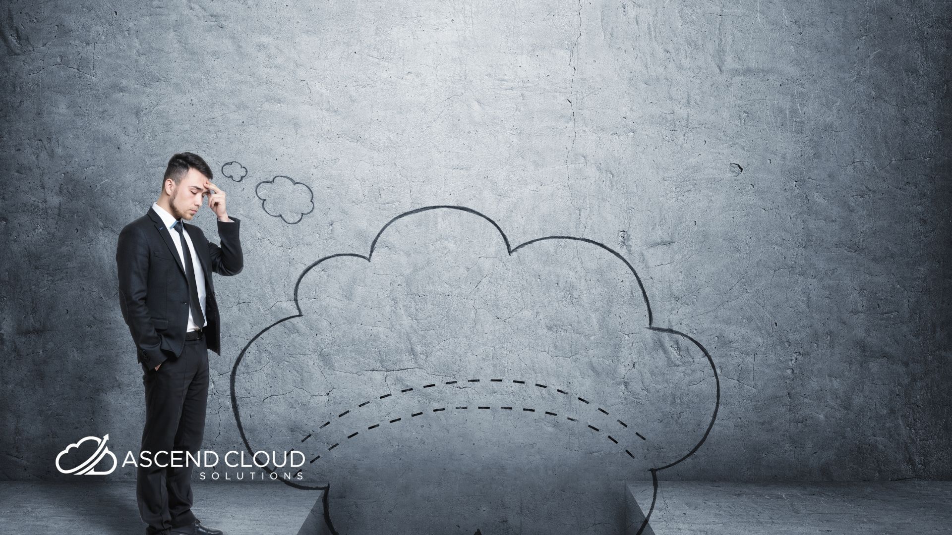 A man in a suit is standing in front of a concrete wall with a thought bubble drawn on it.