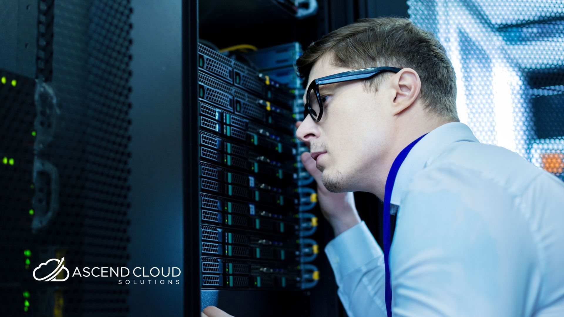 A man is working on a server in a data center.