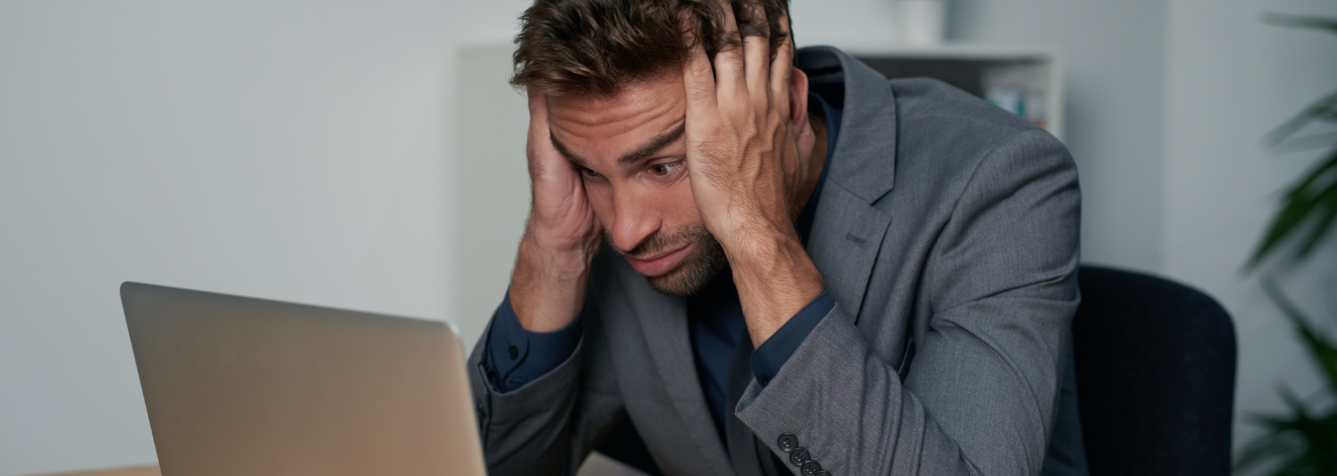 Picture of a businessperson looking stressed and overwhelmed.