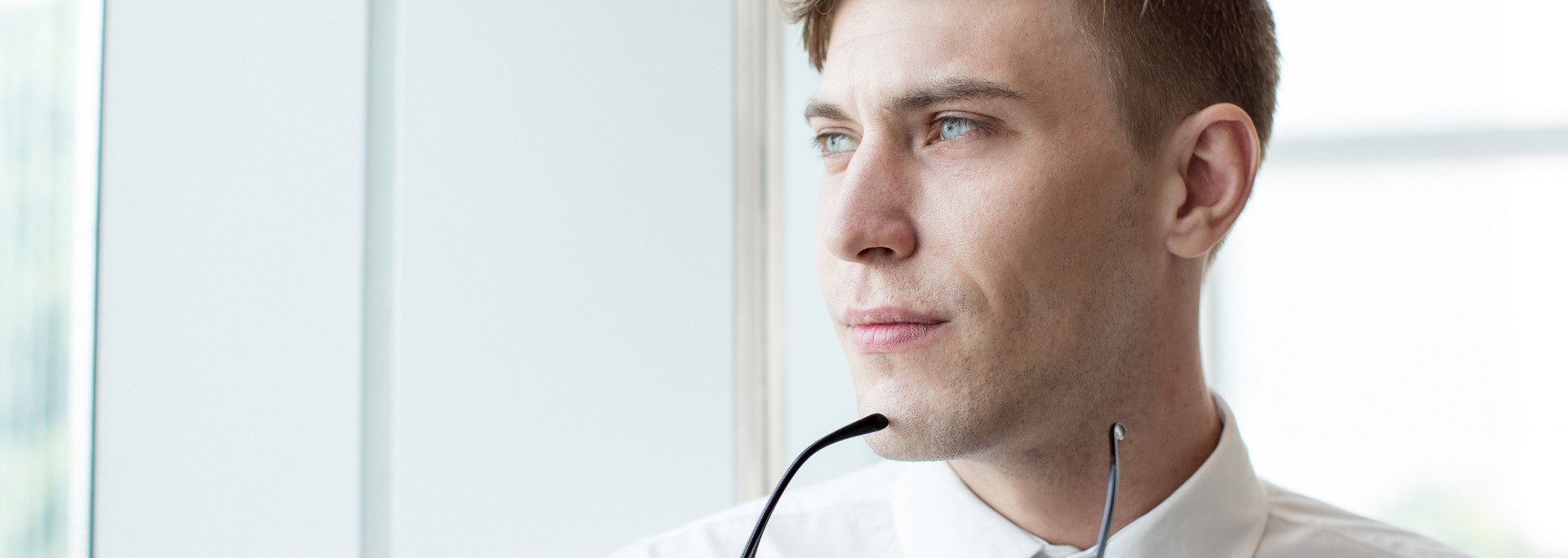 Picture of a businessperson looking through a window.