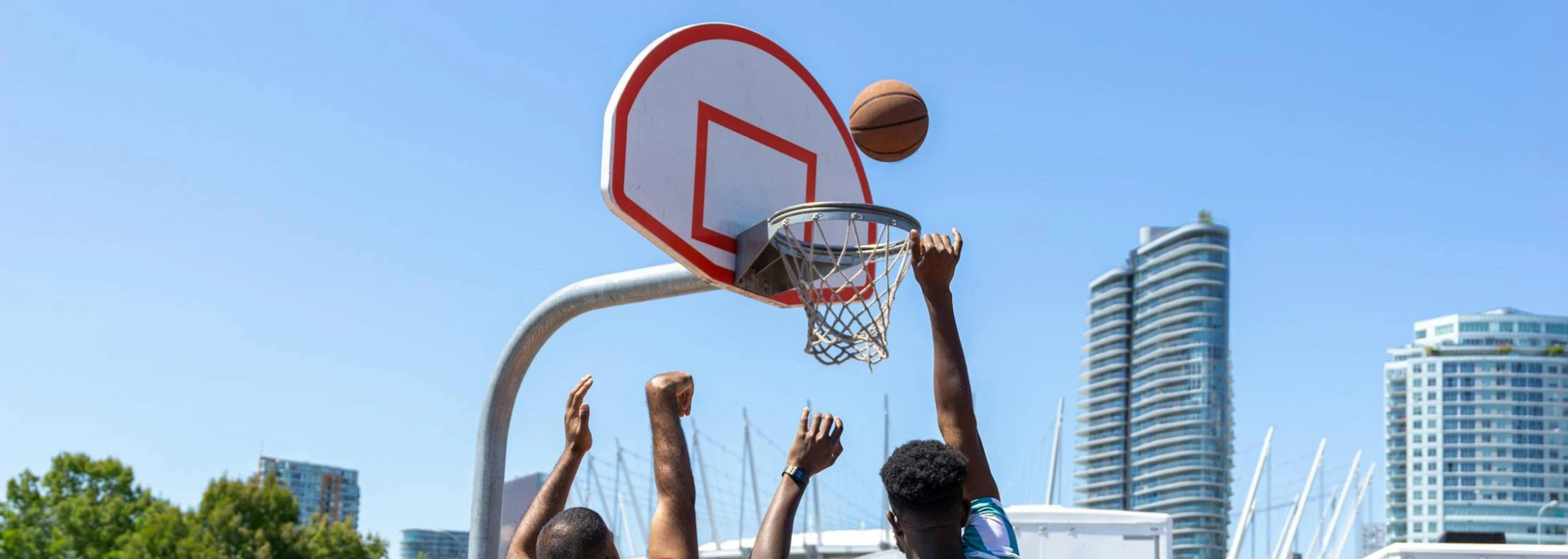 Picture of basketball players shooting hoops.