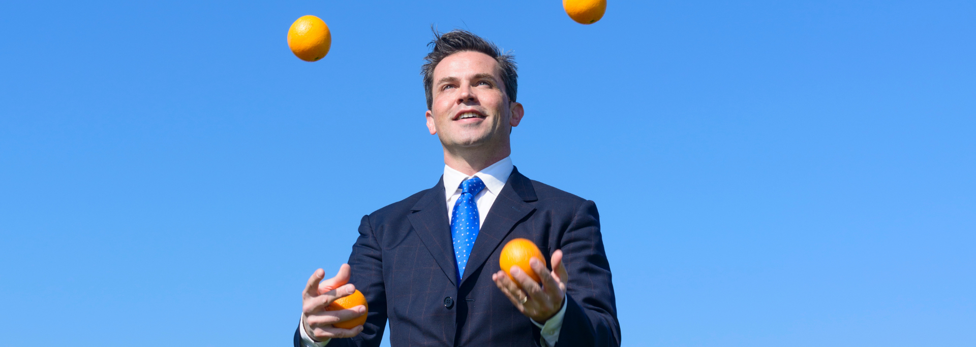 Picture of a businessperson juggling.