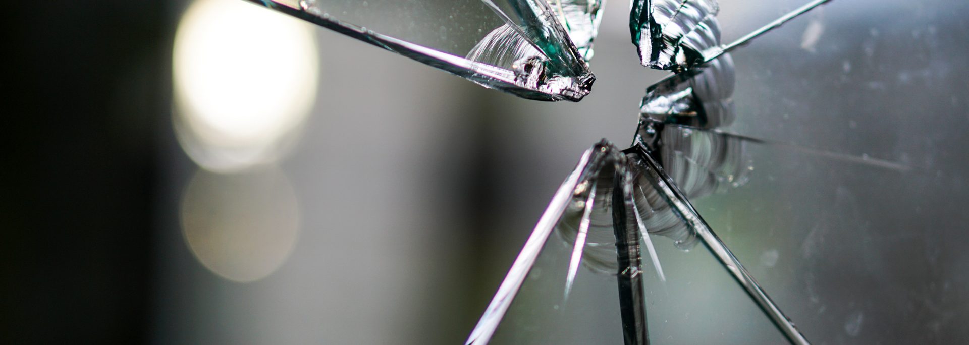 A close up of a broken glass window.