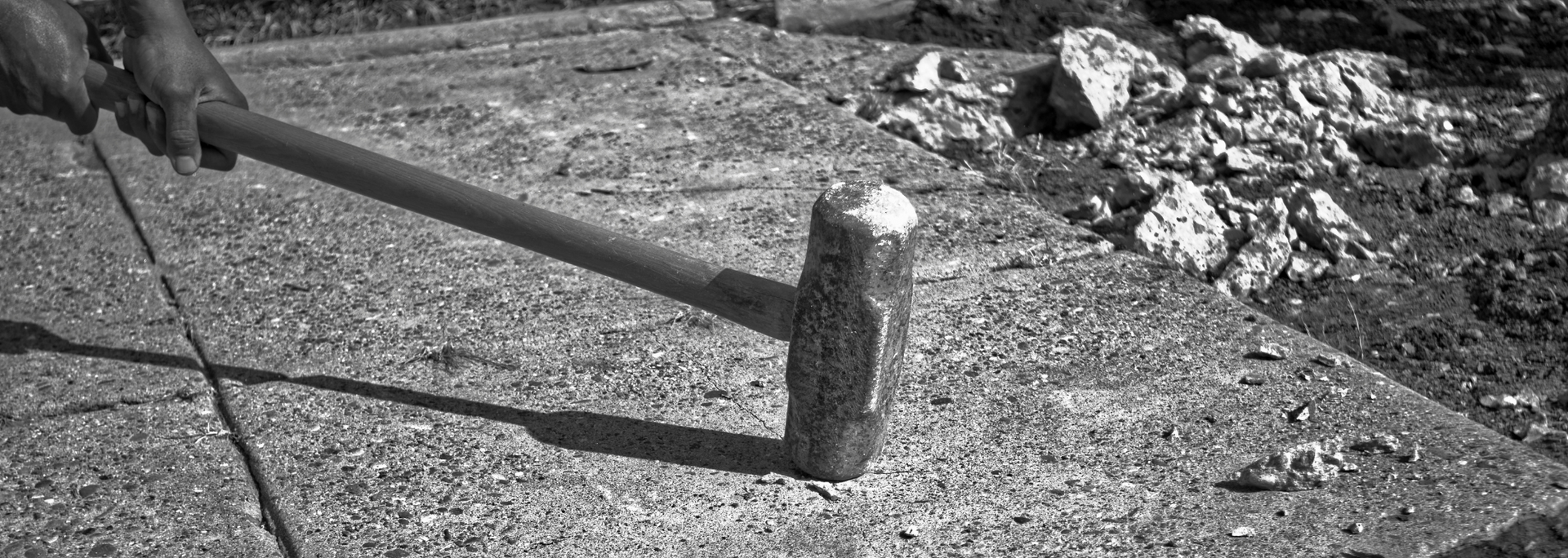 Picture of a nut being cracked with a sledgehammer.