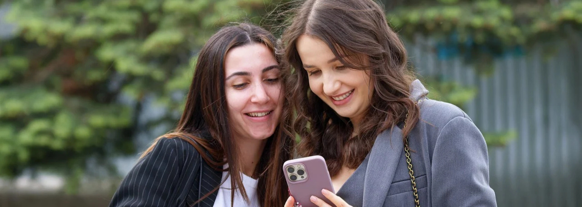 Picture of someone looking happy at a smartphone.