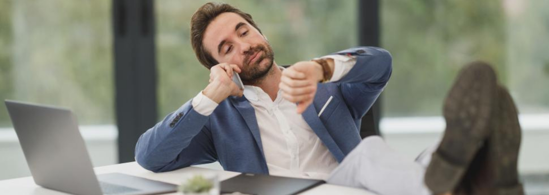 Picture of someone sitting back at their desk.