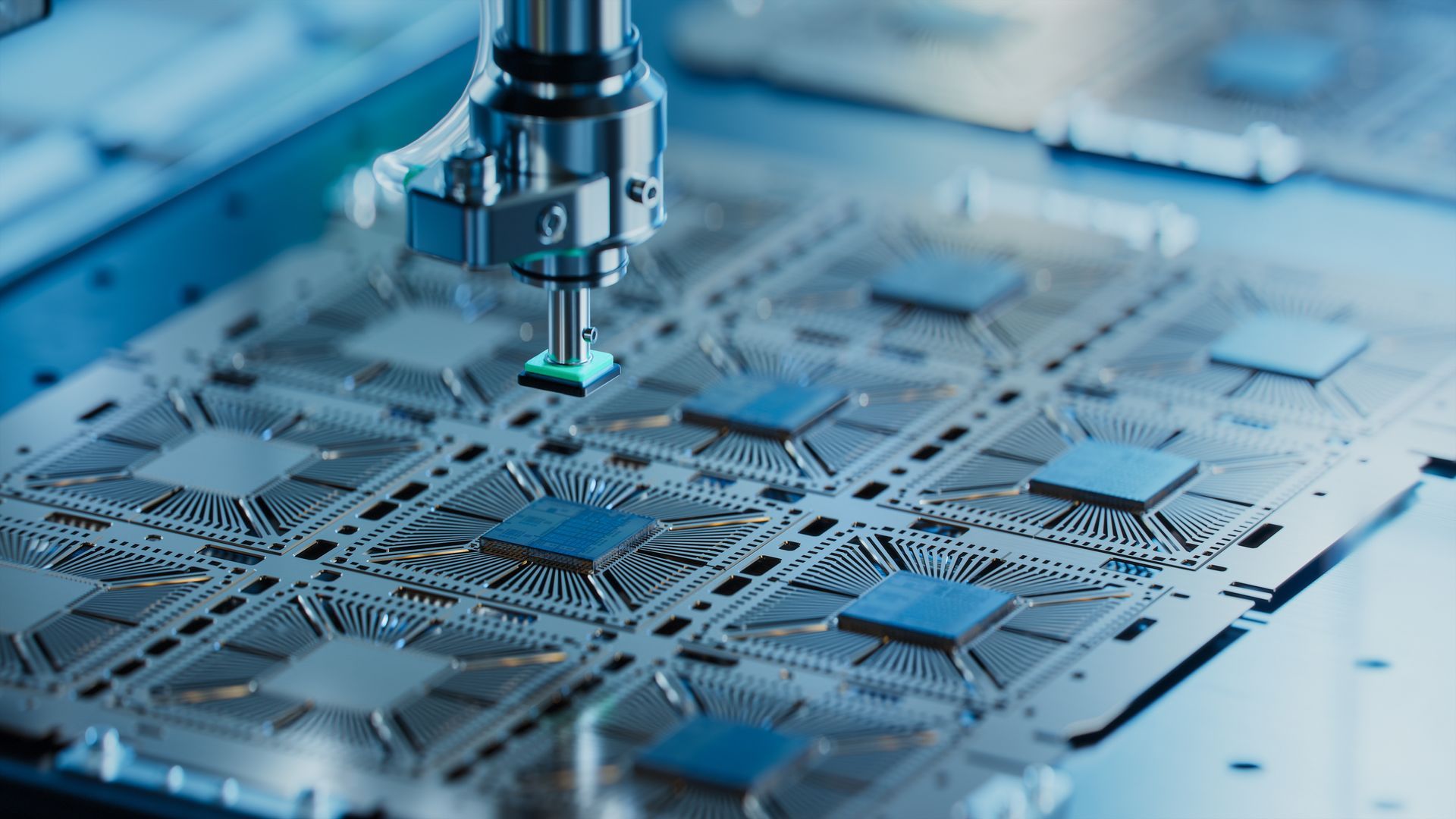 A machine is working on a motherboard in a factory.