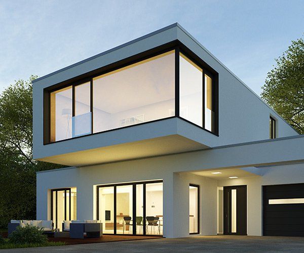 modern home with large windows at dusk