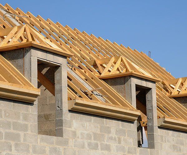 tan brick building with wood framed roof