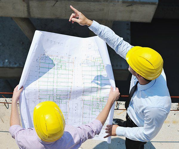 two construction managers discussing floor plan