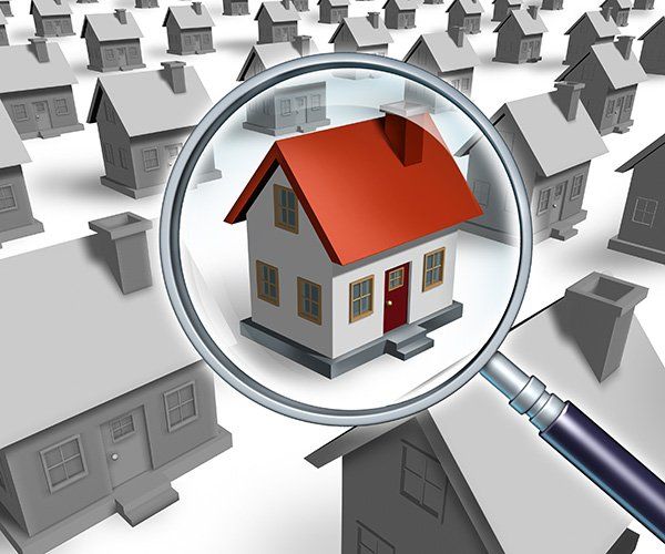 3D illustration of homes with a magnify glass over home with red roof