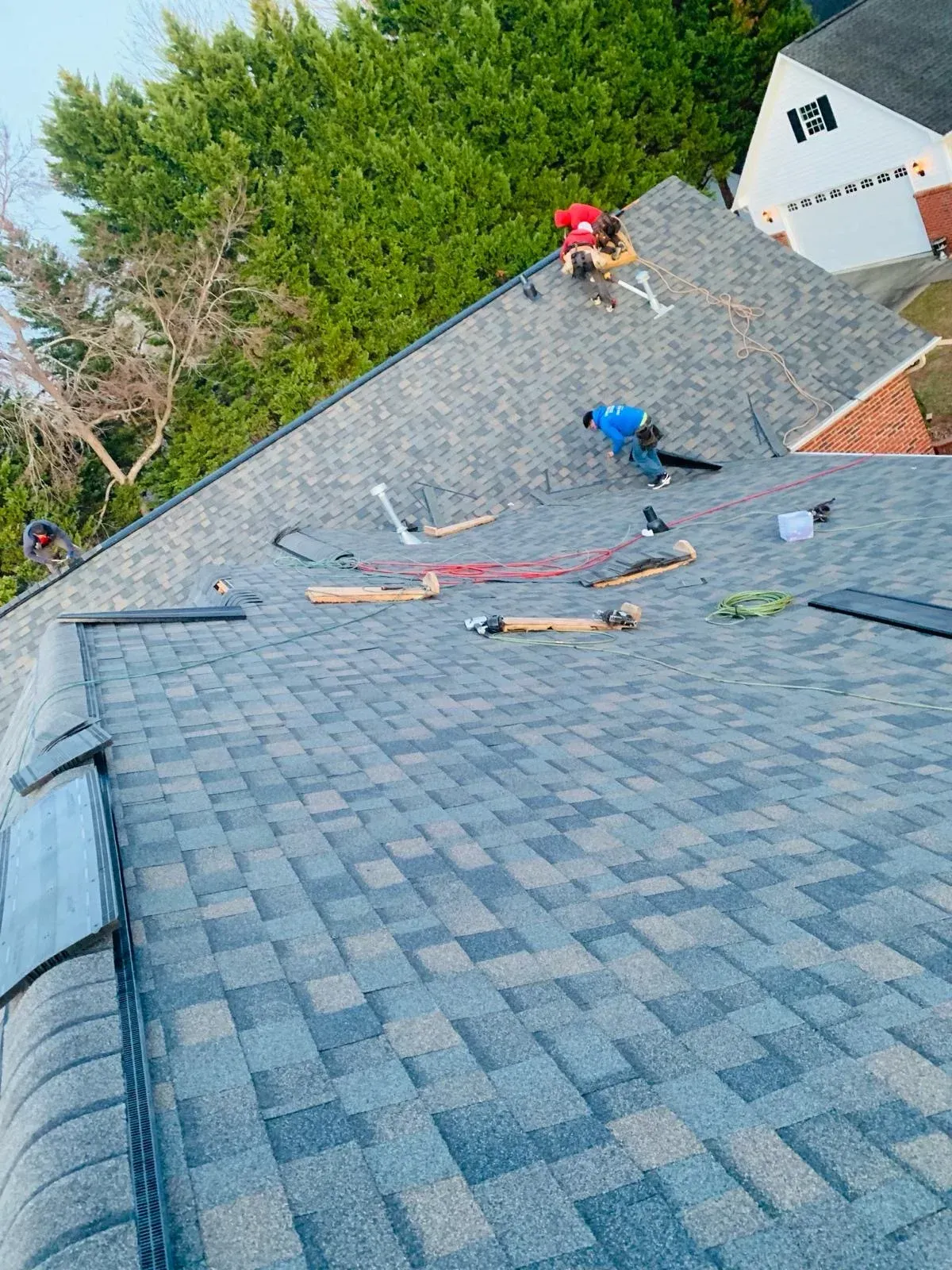 A man is working on the roof of a house.