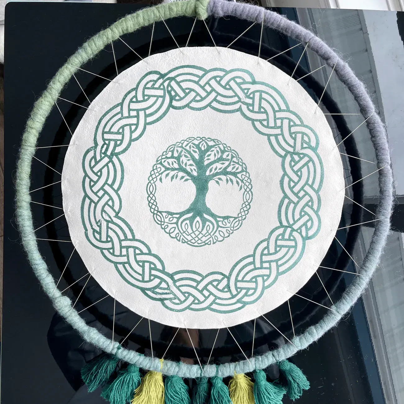 Dream catcher with Celtic knot design in green and white.
