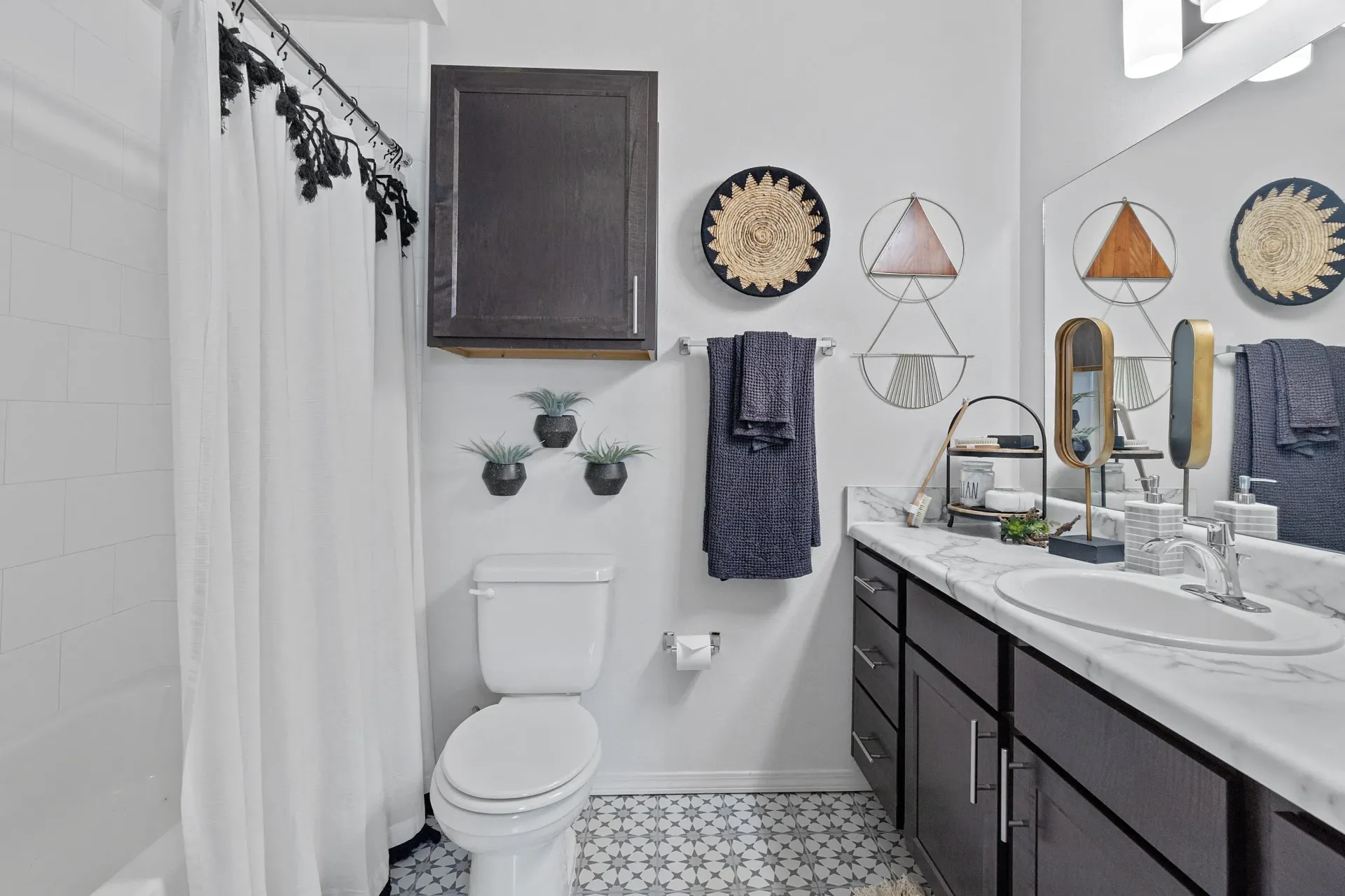 Modern bathroom with a bathtub, toilet, and stylish decor.