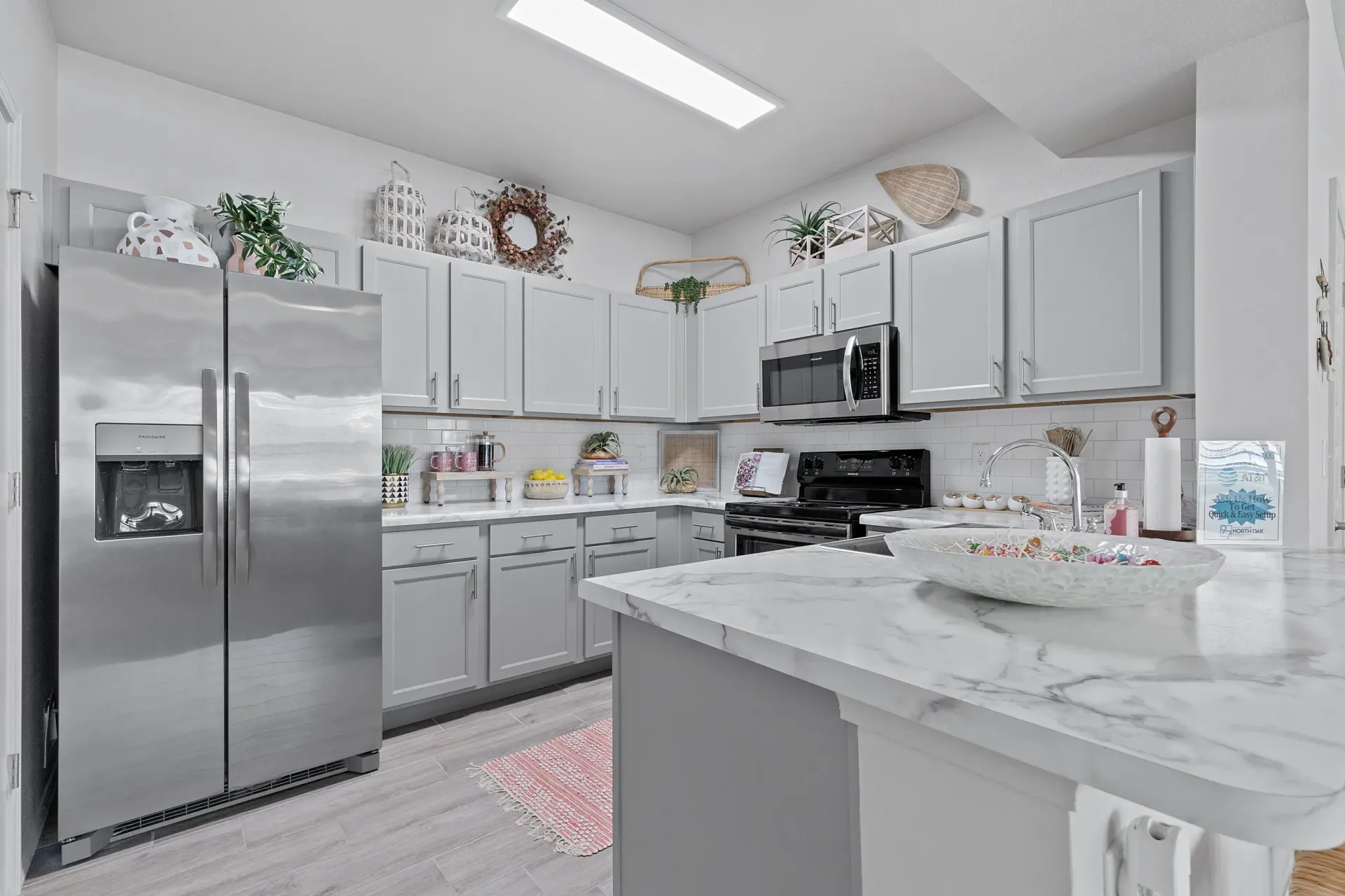 Modern kitchen with stainless steel appliances and marble countertops