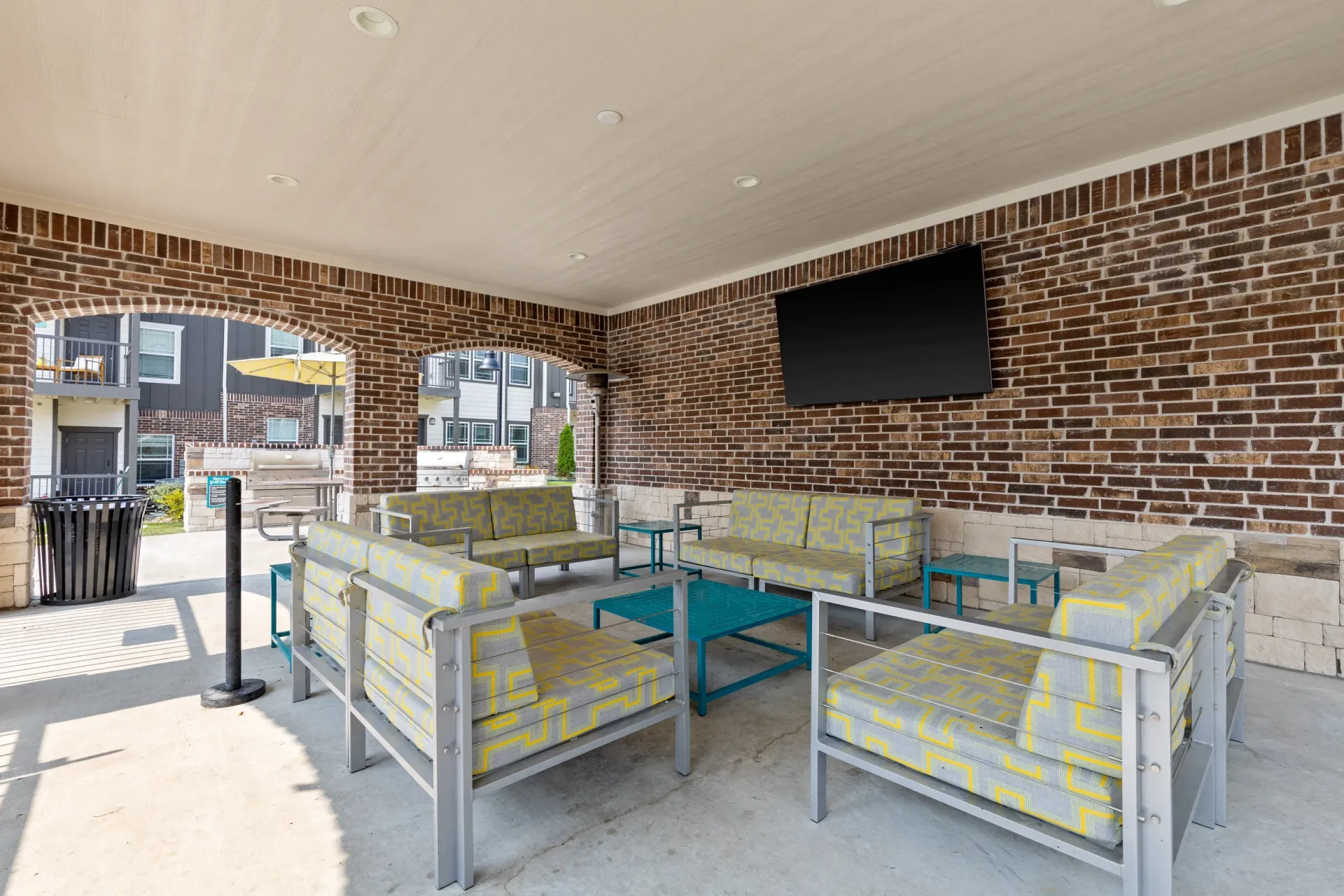 Outdoor lounge area with patterned chairs and table