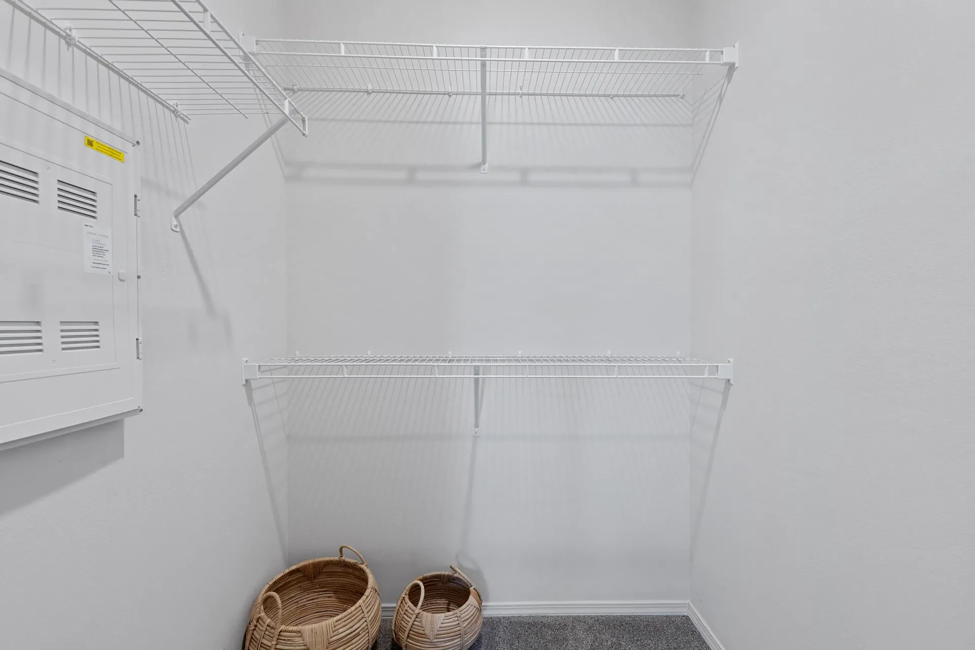 Interior view of a closet with shelving and baskets.