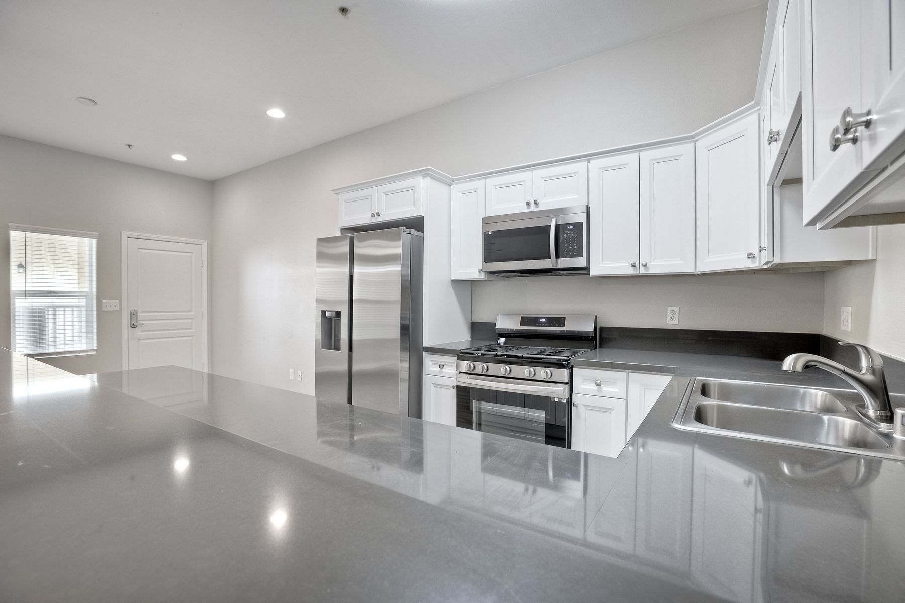 Photo of a kitchen, seen from a barstool area