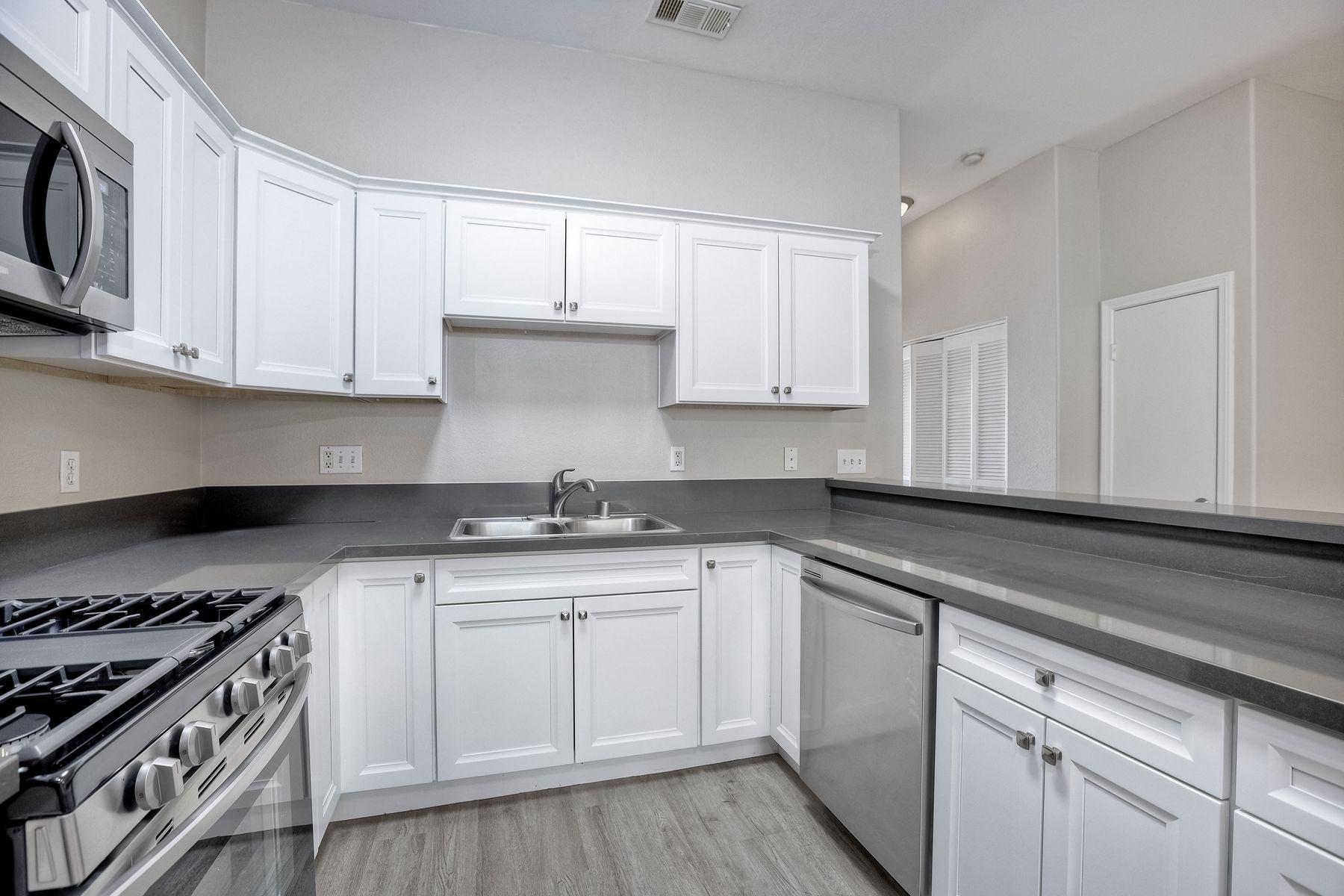 Photo of a wraparound kitchen, seen from a different angle