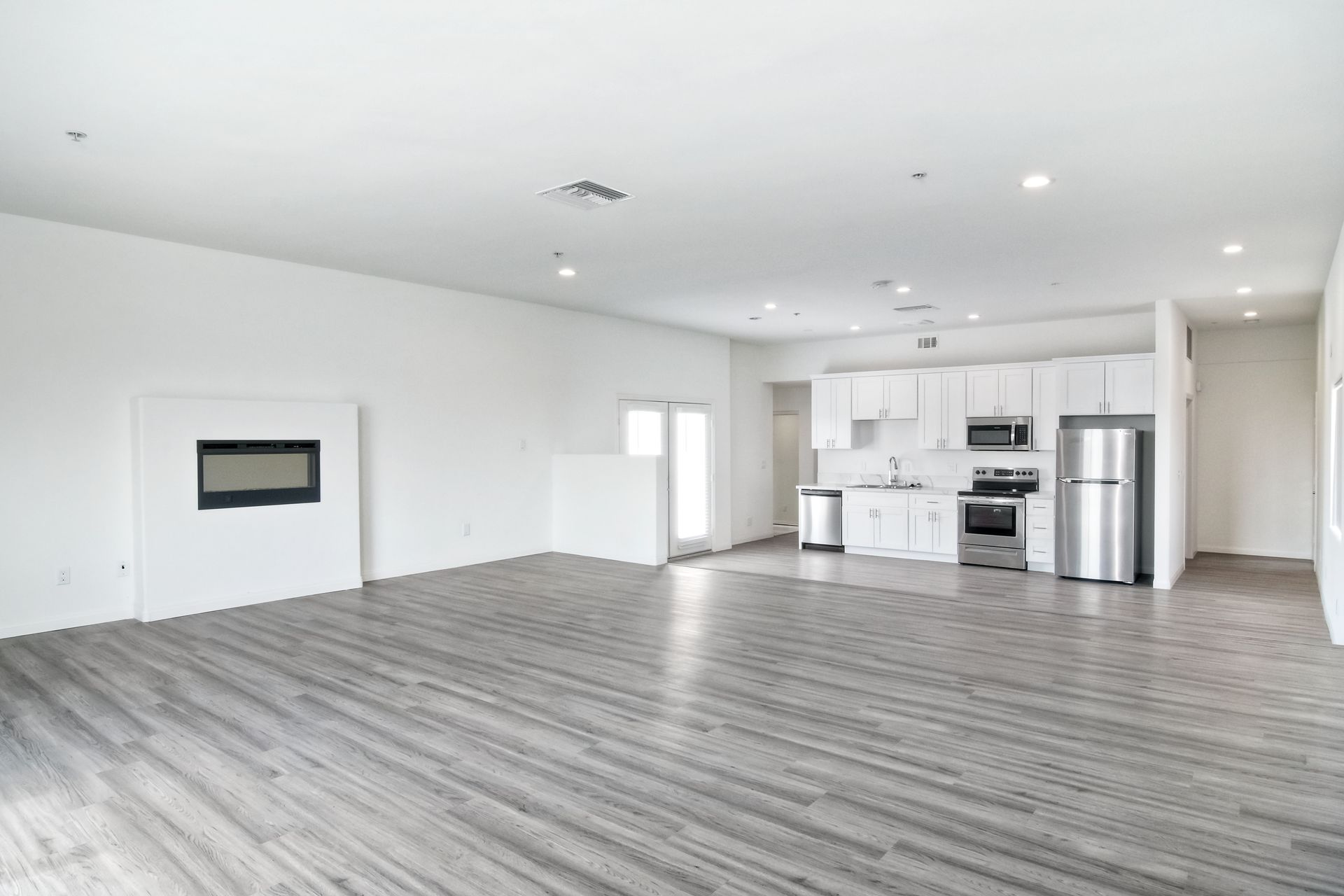 Photo of a the living room's elevated space and the kitchen in the background