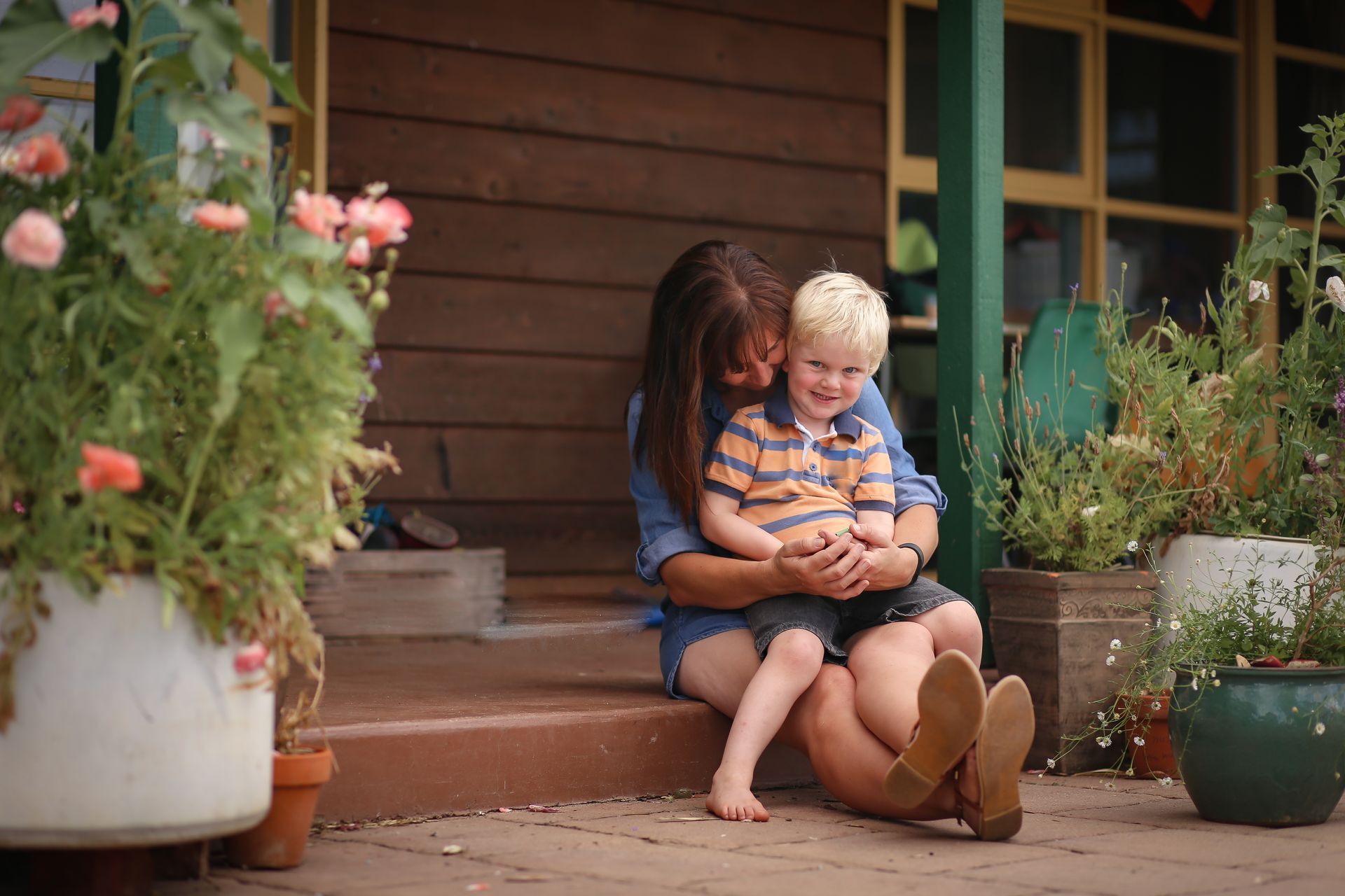 Motorcycle and two cars involved in a collision on a road. A police officer stands nearby.