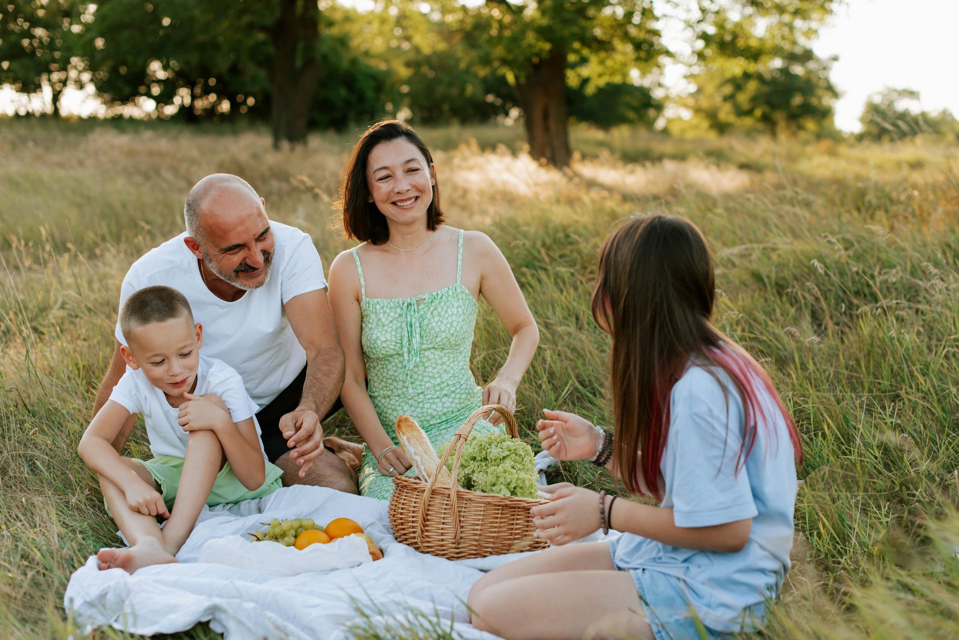Motorcycle and two cars involved in a collision on a road. A police officer stands nearby.