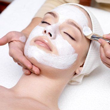 Woman receiving facial in salon
