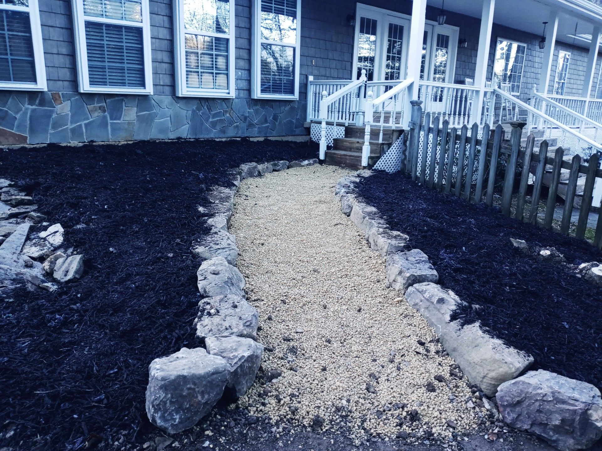 A white truck is parked on the side of a stone walkway