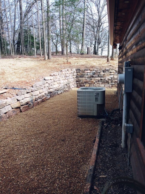 An air conditioner is sitting on the side of a log cabin.