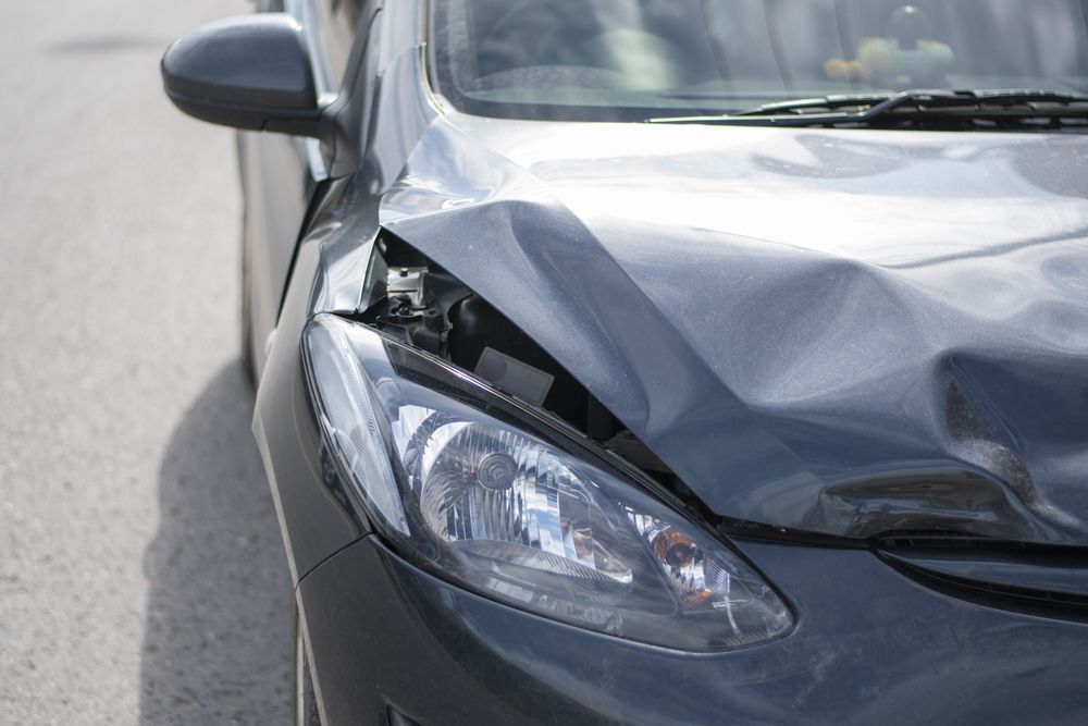 A Car With a Damaged Hood and Headlight — ACT Law Associates In Canberra, AC