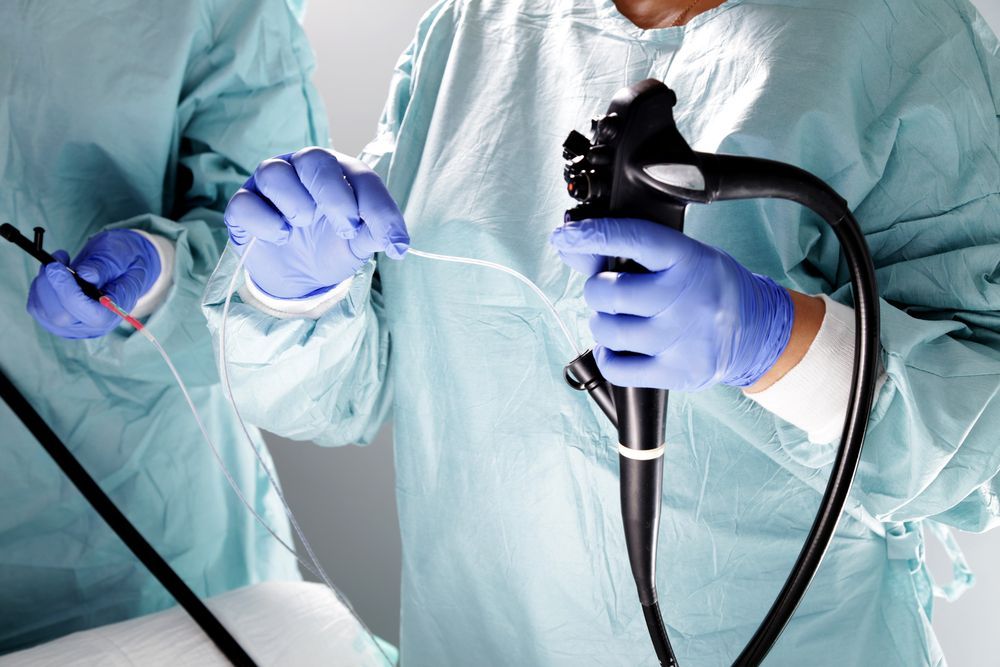 A Surgeon is Holding an Endoscope in Their Hands — ACT Law Associates In Canberra, ACT