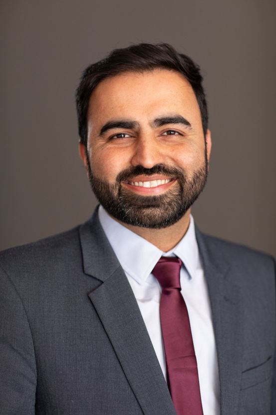 A Man in a Suit is Posing for a Headshot — ACT Law Associates In Canberra, ACT