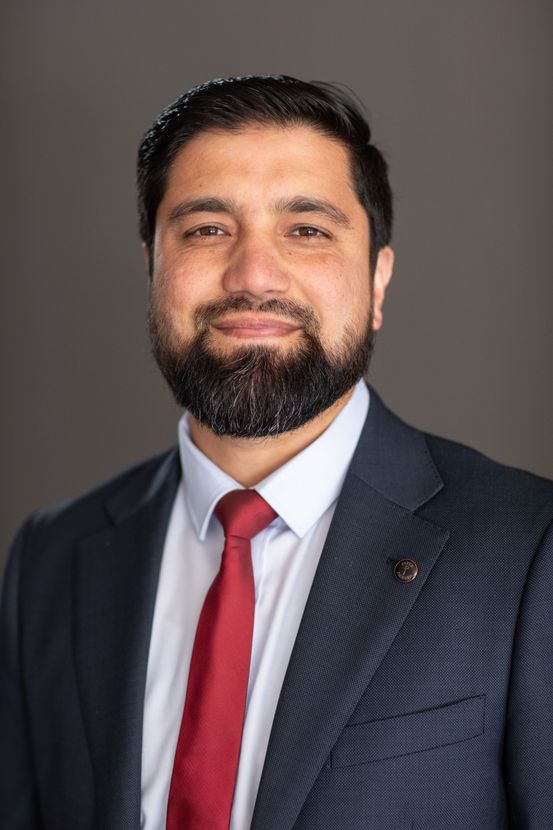 A Man in a Suit is Posing for a Headshot — ACT Law Associates In Canberra, ACT
