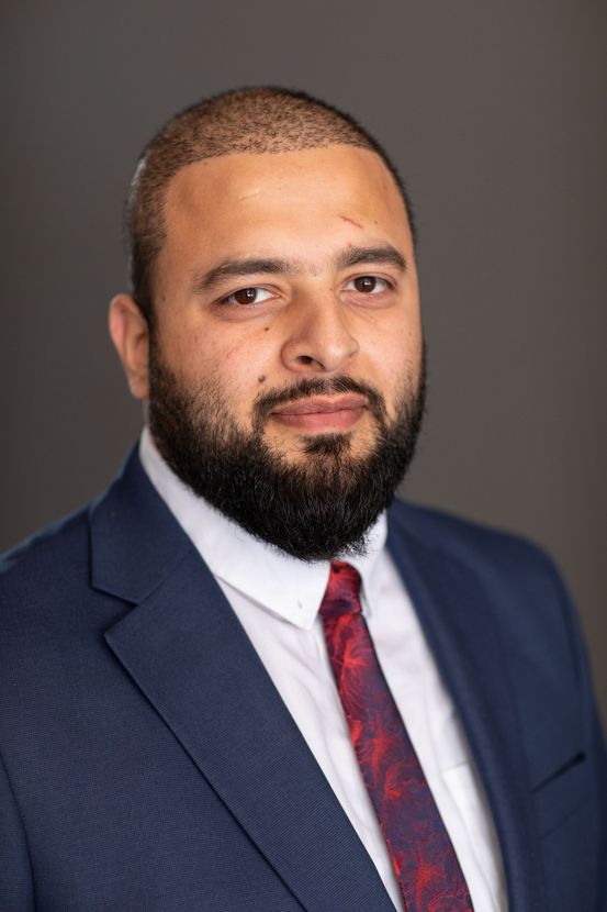 A Man in a Suit is Posing for a Headshot — ACT Law Associates In Canberra, ACT