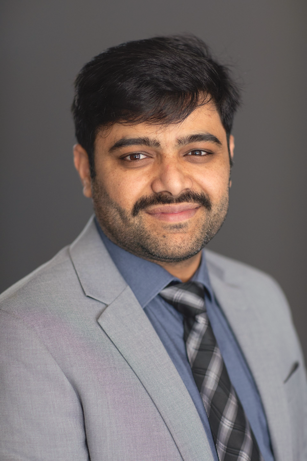 A Man in a Suit is Posing for a Headshot — ACT Law Associates In Canberra, ACT