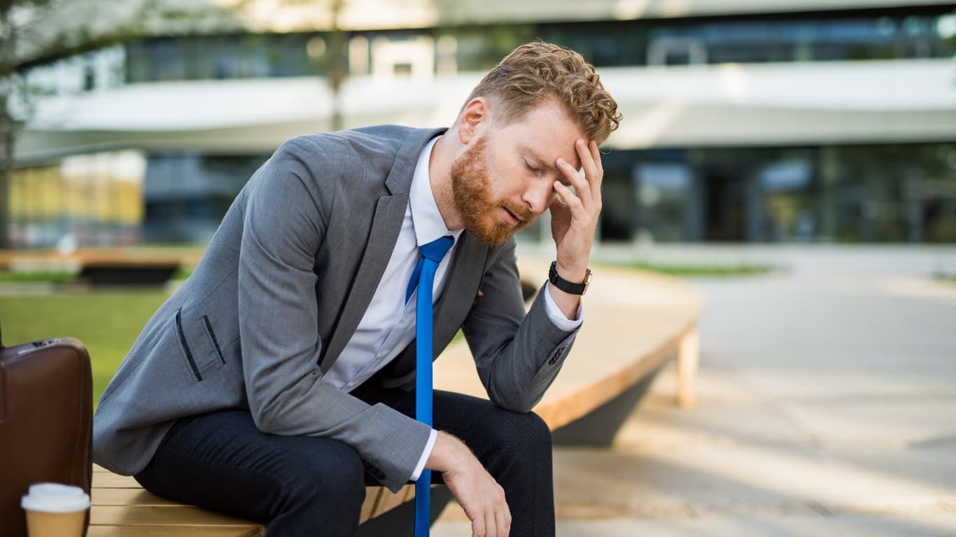 A Man In A Suit Is Sitting On A Bench  — ACT Law Associates In Canberra, ACT