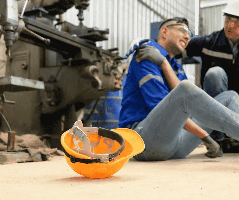A Man is Sitting on the Ground With a Hard Hat Next to Him — ACT Law Associates In Gungahlin, ACT