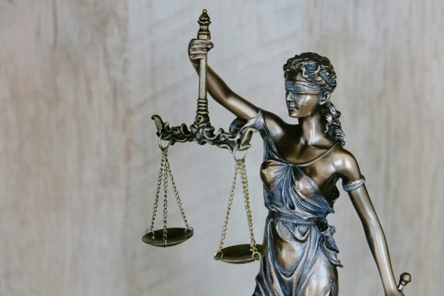 A Statue Of A Blindfolded Woman Holding A Scale Of Justice — ACT Law Associates In Canberra, ACT
