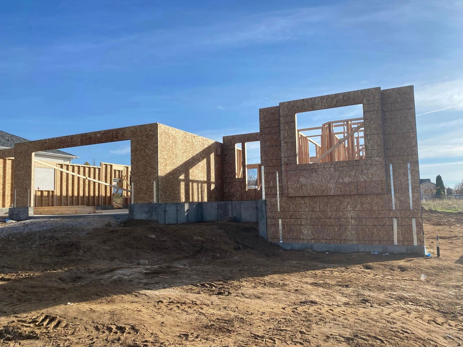 A house is being built in a dirt field.