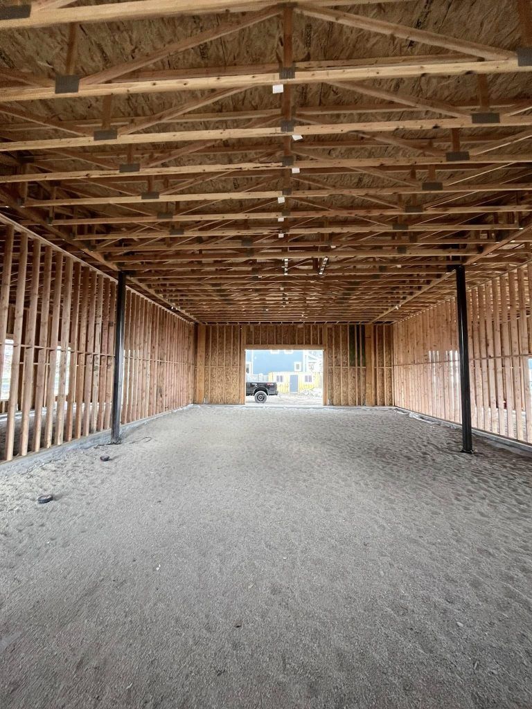 A large empty building under construction with a lot of wooden beams.