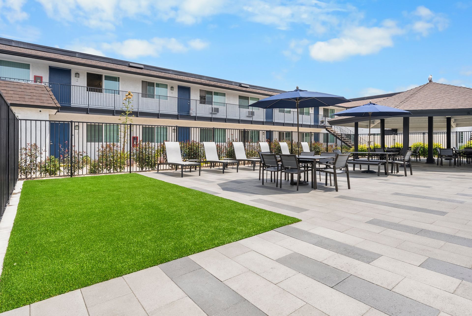 Picnic tables, lounge chairs, and turf patch