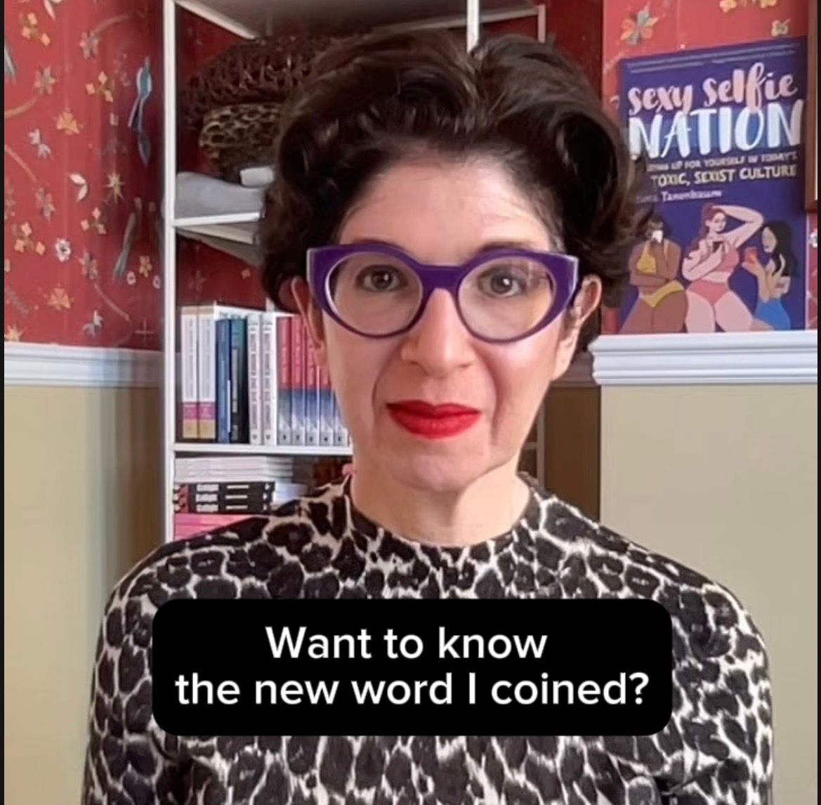 Leora Tanenbaum wearing leopard-print top and purple glasses with text saying,