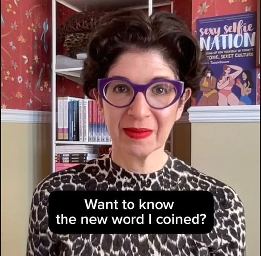 Leora Tanenbaum wearing leopard-print top and purple glasses with text saying, 